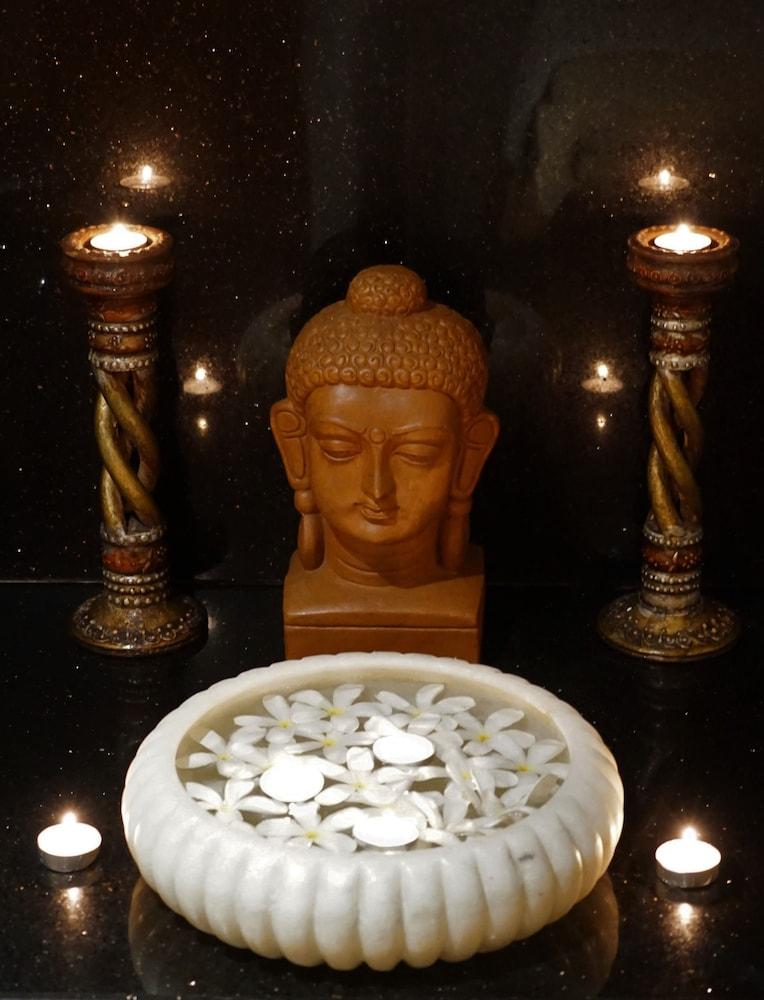 Taj Chandigarh Exterior photo A statue of the Buddha with two oil lamps